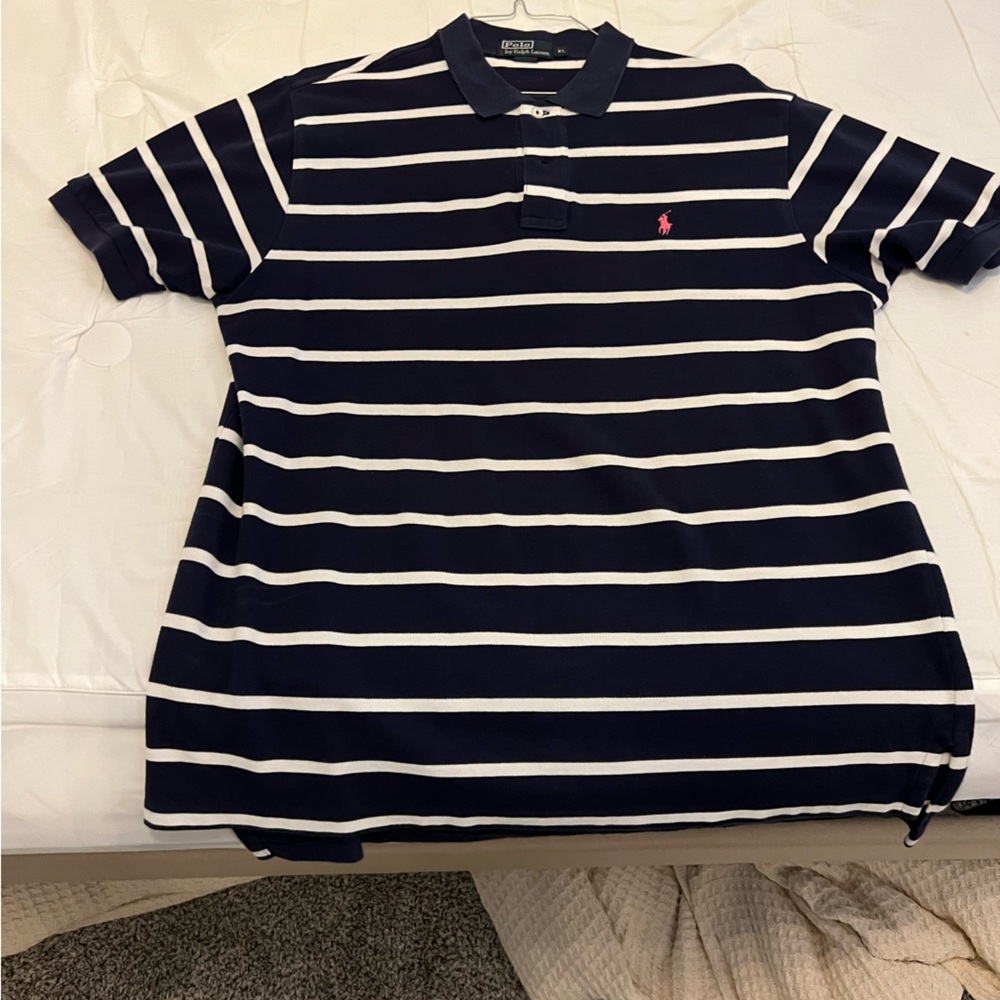 Blue polo with pink logo.
